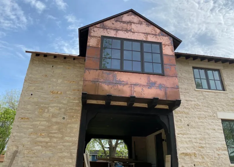 Copper metal panel facade on a stone building for Skylight Installation in Lincolnia